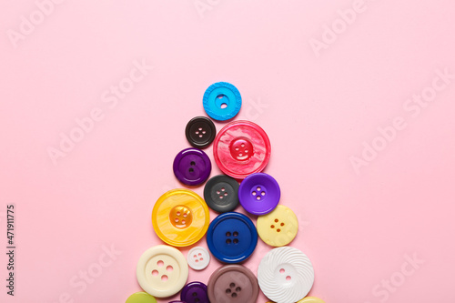 Christmas tree made of buttons on color background