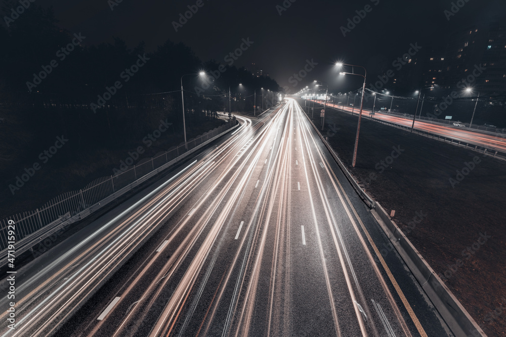 Foggy misty night. Road illuminated by street lights, aerial view