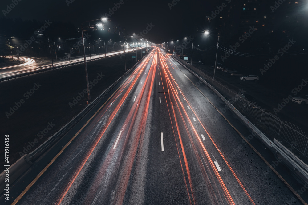 Foggy misty night. Road illuminated by street lights, aerial view