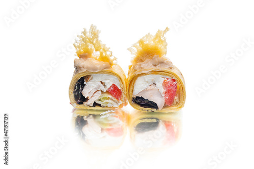 Fototapeta Naklejka Na Ścianę i Meble -  Two pieces of sushi roll with cheese tortilla, parmesan cheese on top. Chicken, tomato, lettuce, cucumber inside roll. Asian roll dish isolated on white background. Copy space image with reflection 
