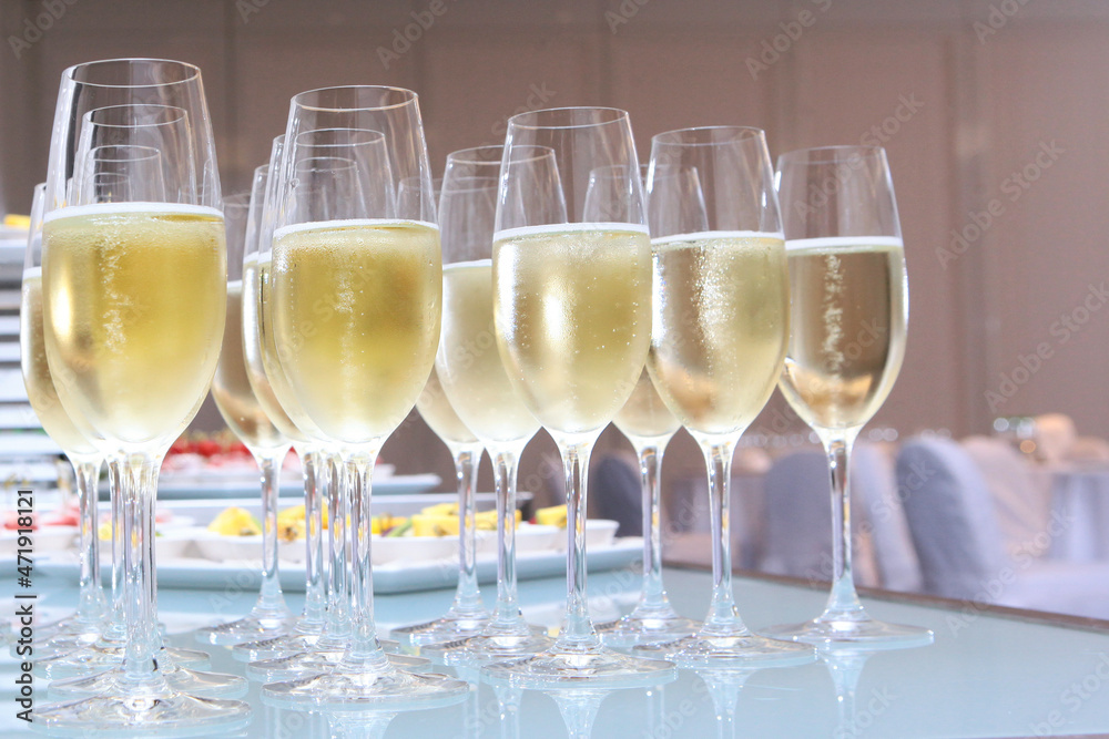Glasses with champagne on the table. High reception. Buffet at a secular party.Lots of wine glasses. Holidays concept. Glasses with champagne on the table. High reception. Buffet at a secular party.Lots of wine glasses. Holidays concept.