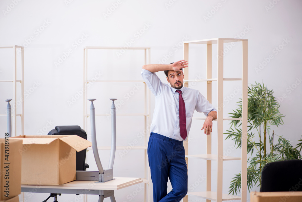 Young male employee in relocation concept Young male employee in relocation concept