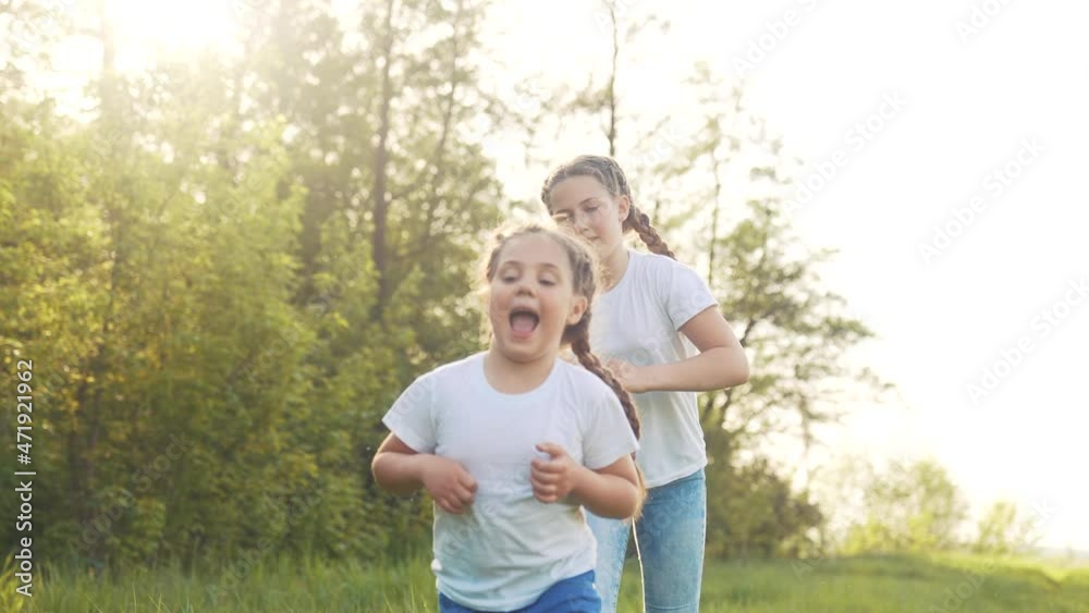 girls kid dream together run in the park at sunset. happy family people in fun the park concept. two sisters playing catch-up run. baby child running in green meadow. happy family kid dream concept girls kid dream together run in the park at sunset. happy family people in fun the park concept. two sisters playing catch-up run. baby child running in green meadow. happy family kid dream concept