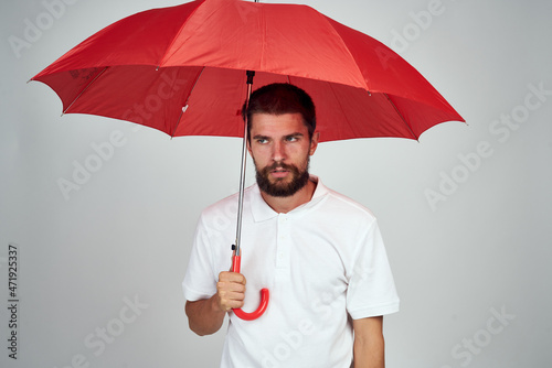 man with umbrella in hands emotions posing light background © VICHIZH