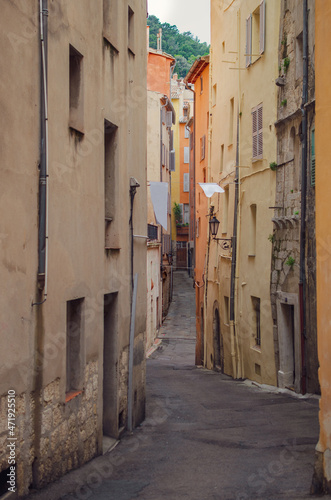 Narrow street with colorful houses in Antibes - Antibes, Côte d'Azur, French Riviera, France © steli[ο]rama