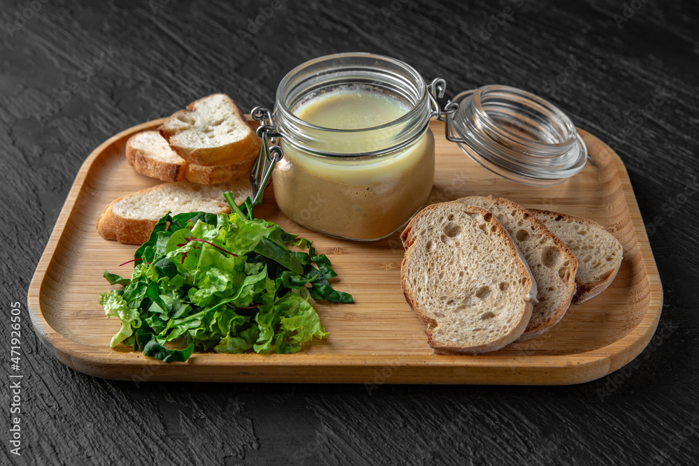 Plateau with pate and toast on a dark textured background. Restaurant menu Isolated on black