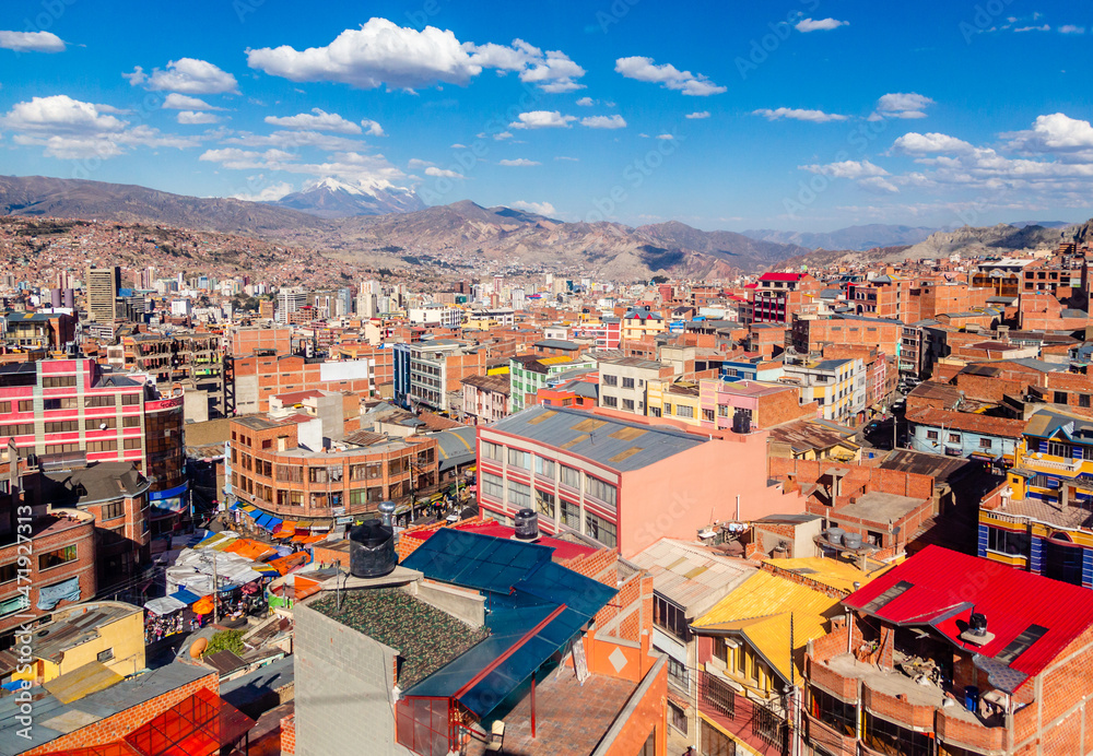 Colorful streets of La Paz with snow cap of Illimani peak, La Paz city, Bolivia