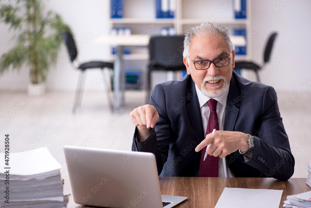 Old male employee and too much work in the office Old male employee and too much work in the office