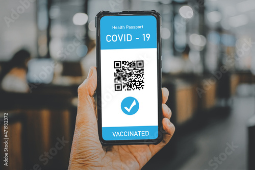Man hand using digital health passport app in mobile phone for travel during covid-19 pandemic, Vaccination passport for covid-19, health and surveillance concepts.
