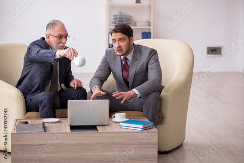 Two businessmen discussing project at workplace © Elnur