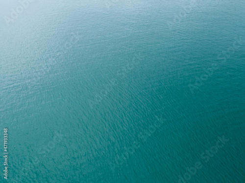 Sea surface aerial view Bird eye view photo of small waves and water surface texture Turquoise sea background Beautiful nature Amazing view