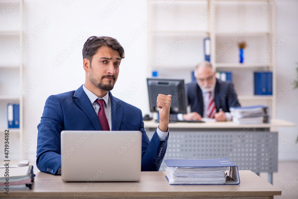 Two male colleagues working in the office Two male colleagues working in the office