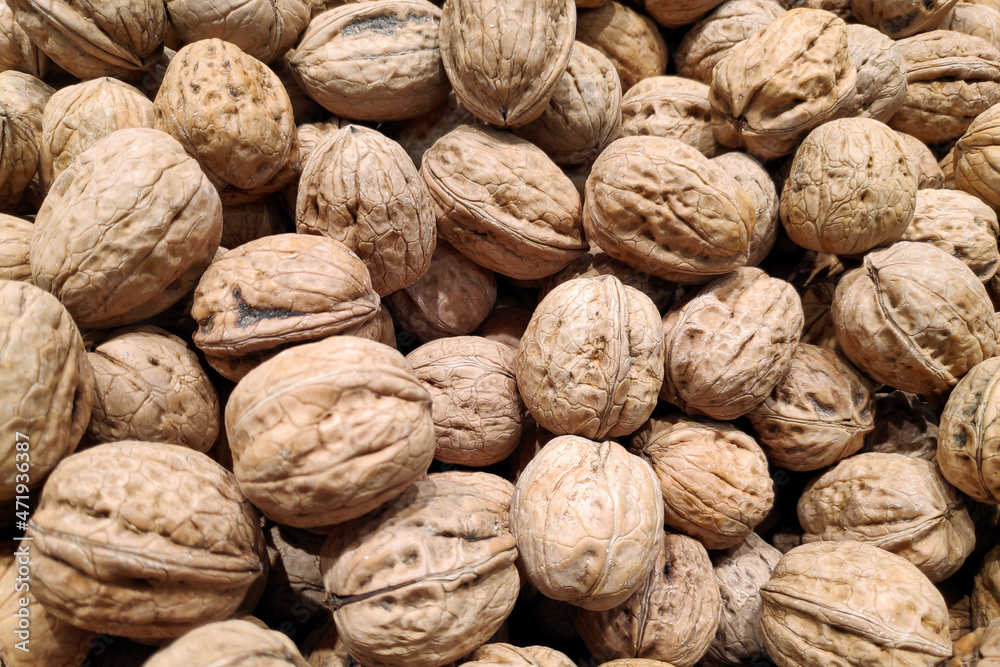 Stack of walnuts on a market stall Stack of walnuts on a market stall