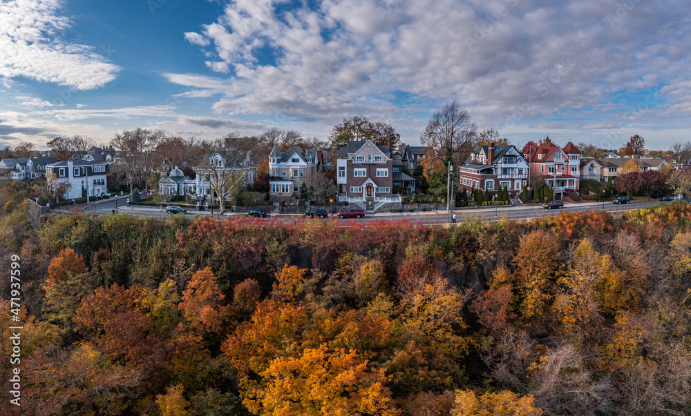 Weehoken New York Full Skyline view point with historic luxury mansions overlooking the Hudson river with orange, yellow fall colors on the trees