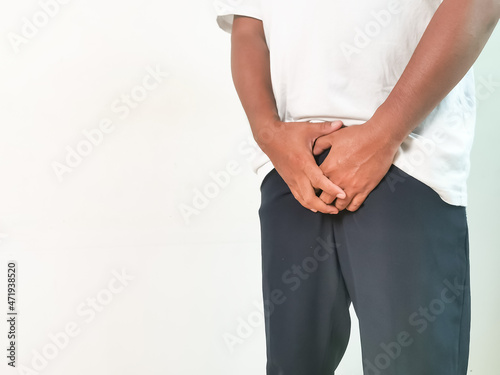Man having a problem with his crotch. Urinary incontinence concept.
