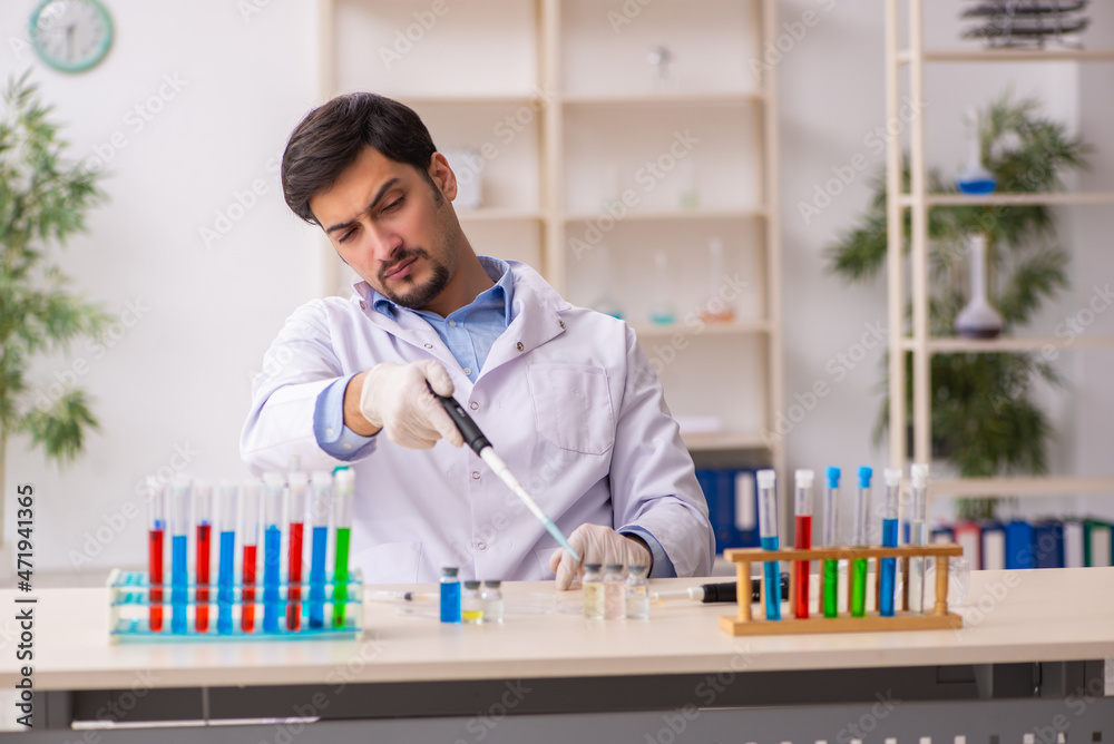 Young male chemist working at the lab Young male chemist working at the lab