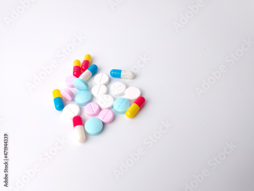 Top view piles of pills and capsule on white background,isolated,copy space.Selective focus.