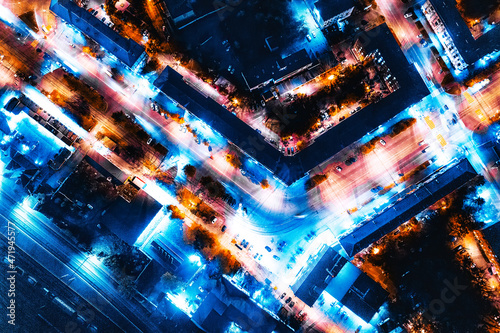 Aerial view of the night city in winter. Movement of cars on lighted streets and intersections