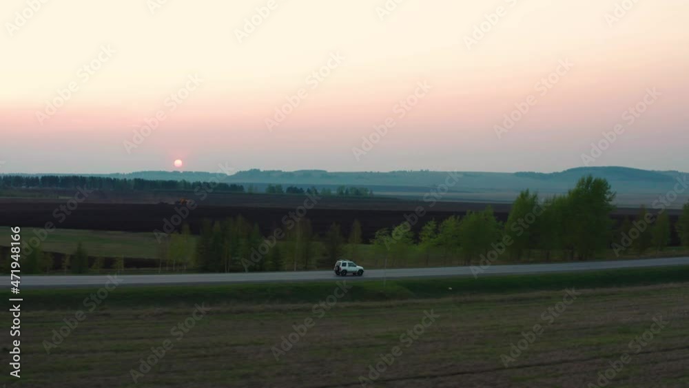 Aerial view of the car driving on the road against the background of the forest