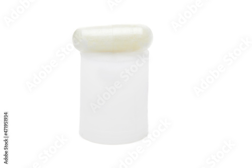 Herbal capsule on the podium, food supplement, vitamin pill, herbal medicine on a white background