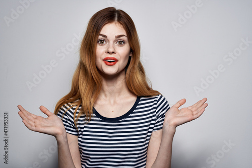 pretty woman in a striped t-shirt gesture with his hands isolated background