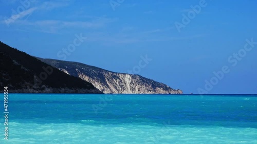 Perfect blue calm waves by the Agia Kiriaki Beach and mountains in Greece -Wide photo