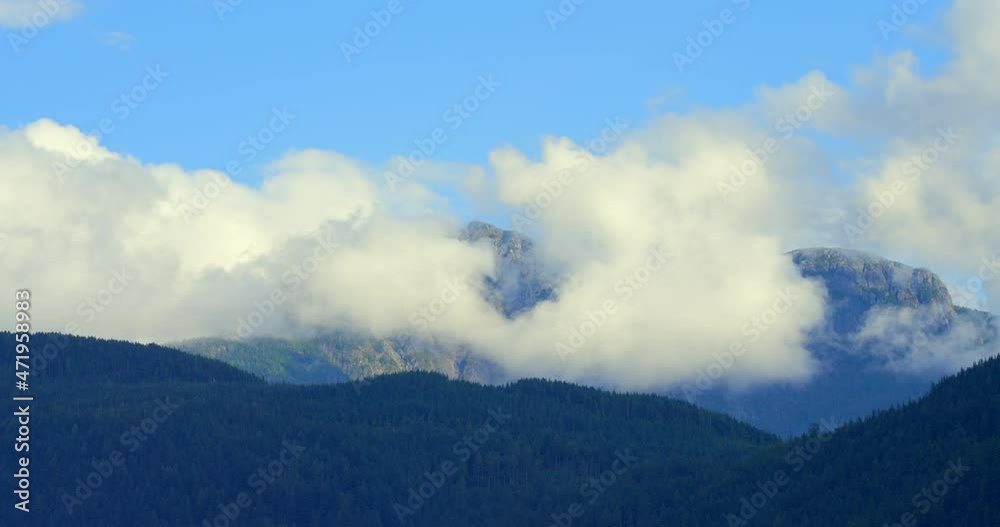 Establishing shot of majestic mountains with forest foreground in Vancouver, Canada, North America. Day time on September 2021. Still camera view. ProRes 422 HQ. Establishing shot of majestic mountains with forest foreground in Vancouver, Canada, North America. Day time on September 2021. Still camera view. ProRes 422 HQ.
