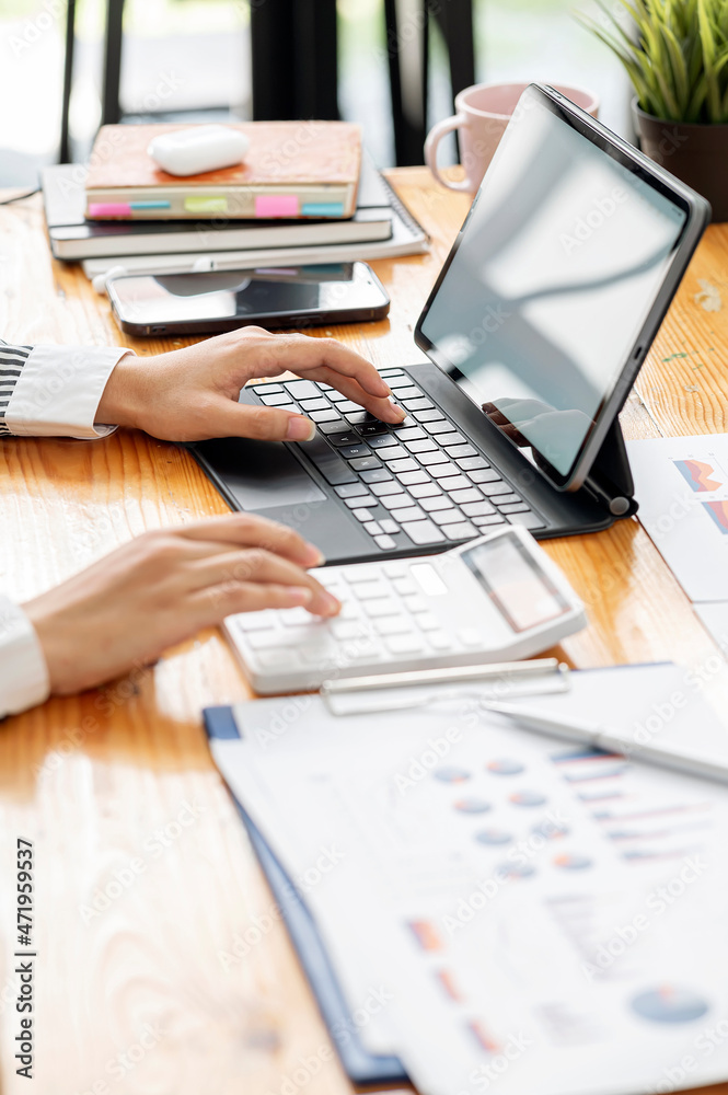 woman hand working on portable table and graph chart. woman hand working on portable table and graph chart.