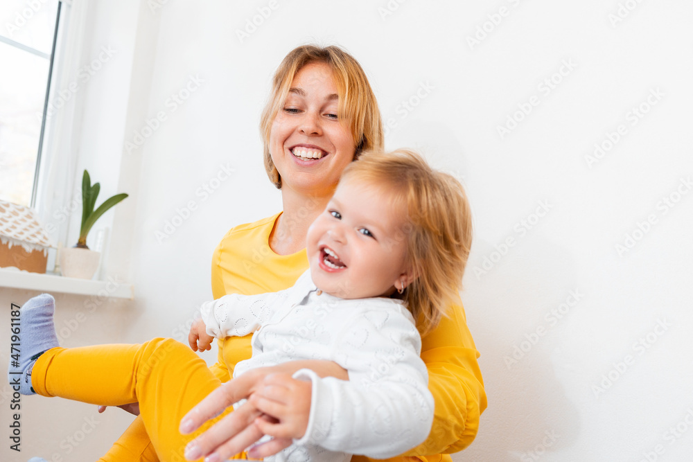 A young mother is playing and having fun with her little child. Concept of happy motherhood A young mother is playing and having fun with her little child. Concept of happy motherhood