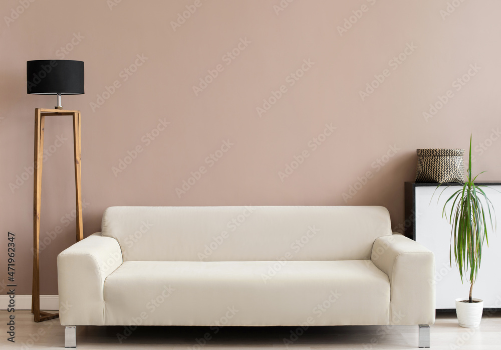 Living room interior wall mockup in warm tones with beige minimal sofa and lamp. Interior mockup with empty wall template Living room interior wall mockup in warm tones with beige minimal sofa and lamp. Interior mockup with empty wall template