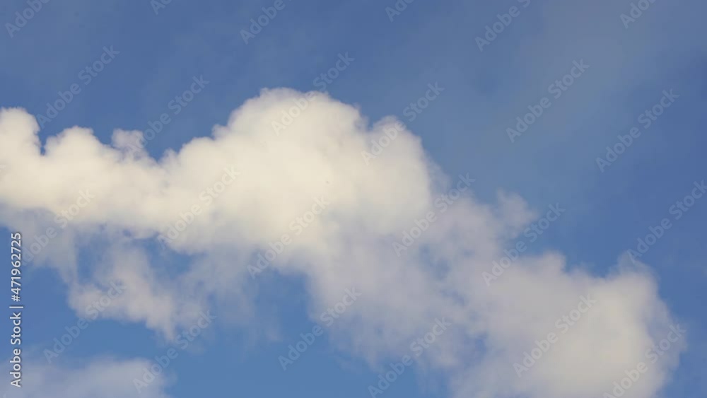 Smoke or steam from the chimney moves slowly against the sky. Smoke or steam from the chimney moves slowly against the sky.