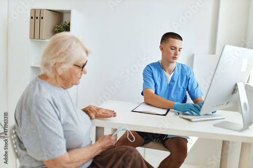 an elderly woman is examined by a doctor health care