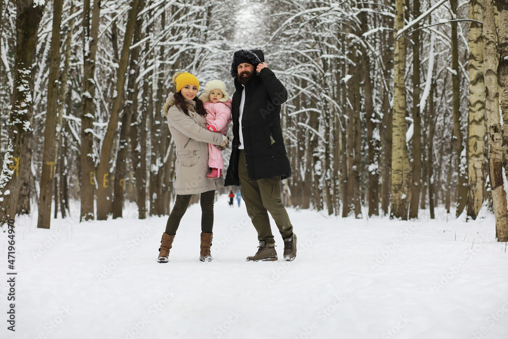 Happy family playing and laughing in winter outdoors in the snow. City park winter day. Happy family playing and laughing in winter outdoors in the snow. City park winter day.