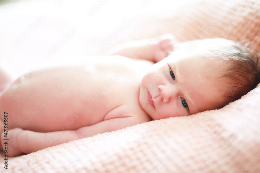 A newborn baby lies in her mother's arms. A beautiful baby of European appearance is sleeping. A newborn baby lies in her mother's arms. A beautiful baby of European appearance is sleeping.