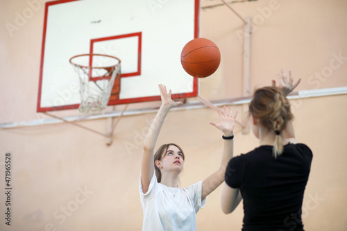 Girl in the gym playing a basketball © alexkich