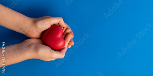 hands holding a red heart concept of health, love, organ donation, family insurance, world heart day, world health day, wellness, gratitude, be kind, be grateful