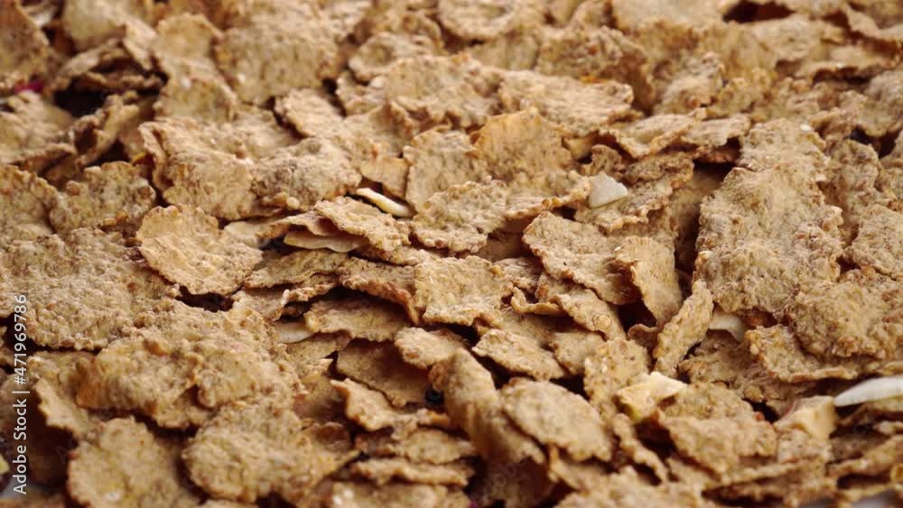 Muesli with dried fruits. Uncooked dry wheat flakes. Close-up. Rotation Muesli with dried fruits. Uncooked dry wheat flakes. Close-up. Rotation