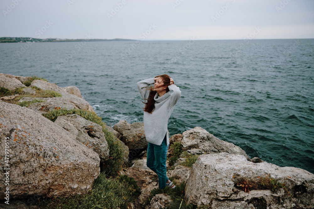 woman long hair nature rocks coast landscape female relaxing woman long hair nature rocks coast landscape female relaxing
