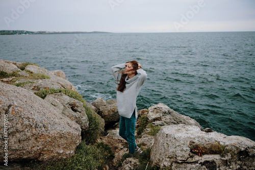 woman long hair nature rocks coast landscape female relaxing