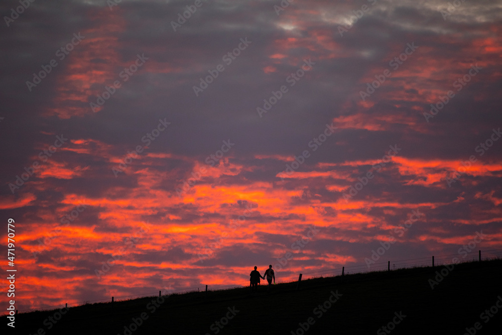 silhouette of a couple on a hill
