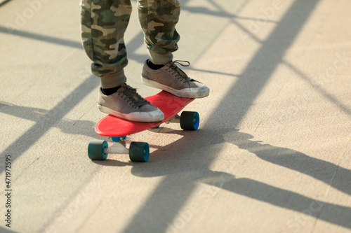 Skateboarder legs riding skateboard at city