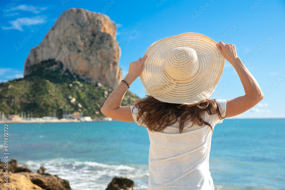 happy woman traveler  with hat enjoy beautiful view on cliff over sea and island