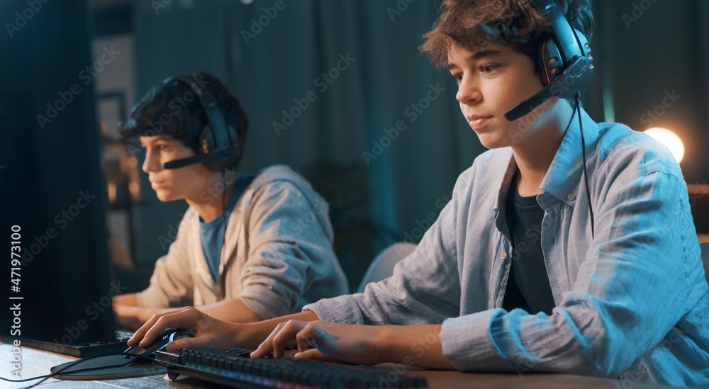 Young gamers playing online multiplayer video games together Young gamers playing online multiplayer video games together