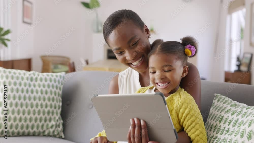 Cute little daughter and african mother using digital tablet to do a video call