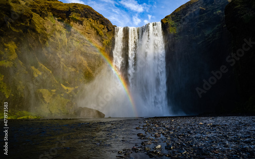 Skogafoss waterfall with rainbow in summer sunshine, South coast, Iceland - 