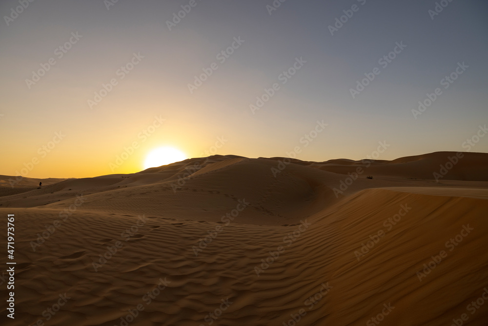 Sunset in the arabian desert with rolling sand dunes in Abu Dhabi, United Arab Emirates Sunset in the arabian desert with rolling sand dunes in Abu Dhabi, United Arab Emirates