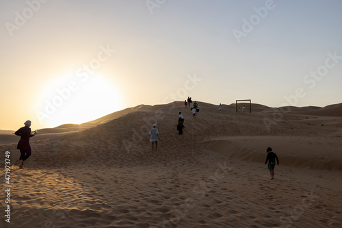 Sunset in the arabian desert with rolling sand dunes in Abu Dhabi  United Arab Emirates