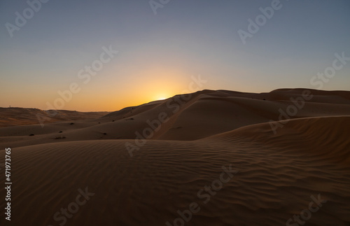 Fototapeta Naklejka Na Ścianę i Meble -  Sunset in the arabian desert with rolling sand dunes in Abu Dhabi, United Arab Emirates