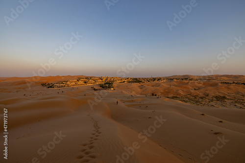 Sunset in the arabian desert with rolling sand dunes in Abu Dhabi  United Arab Emirates