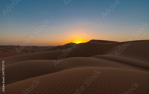 Sunset in the arabian desert with rolling sand dunes in Abu Dhabi, United Arab Emirates © hyserb
